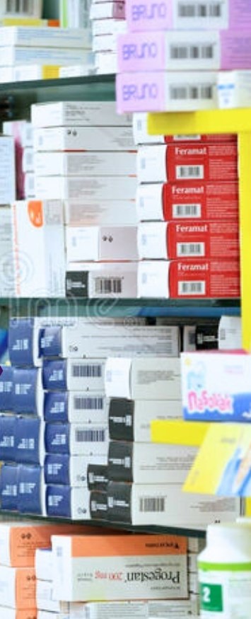 Pharmacy shelving stacked with boxed medicines